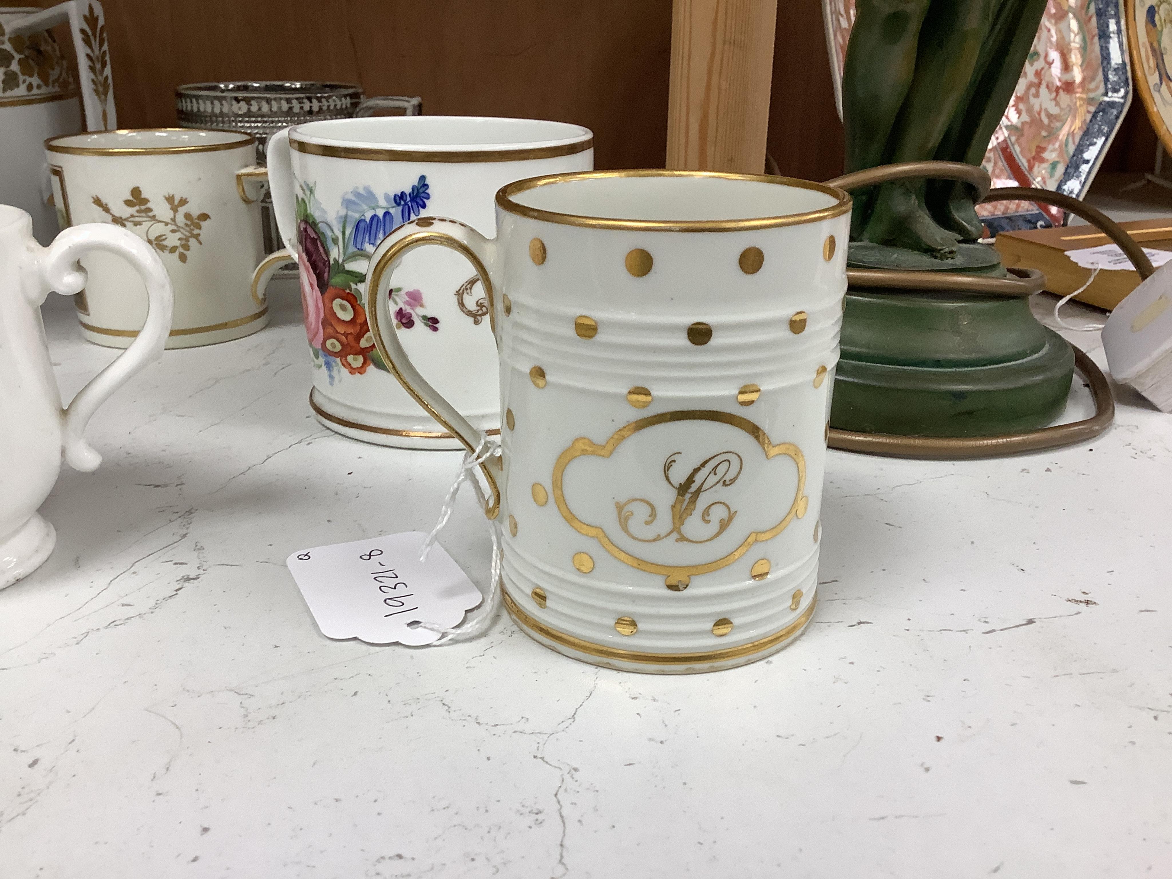 A pair of early 19th century English porcelain large mugs with gilt bands and five other early 19th century porcelain or pearlware mugs, one inscribed SG, Forget Me Not, largest each 14cm high